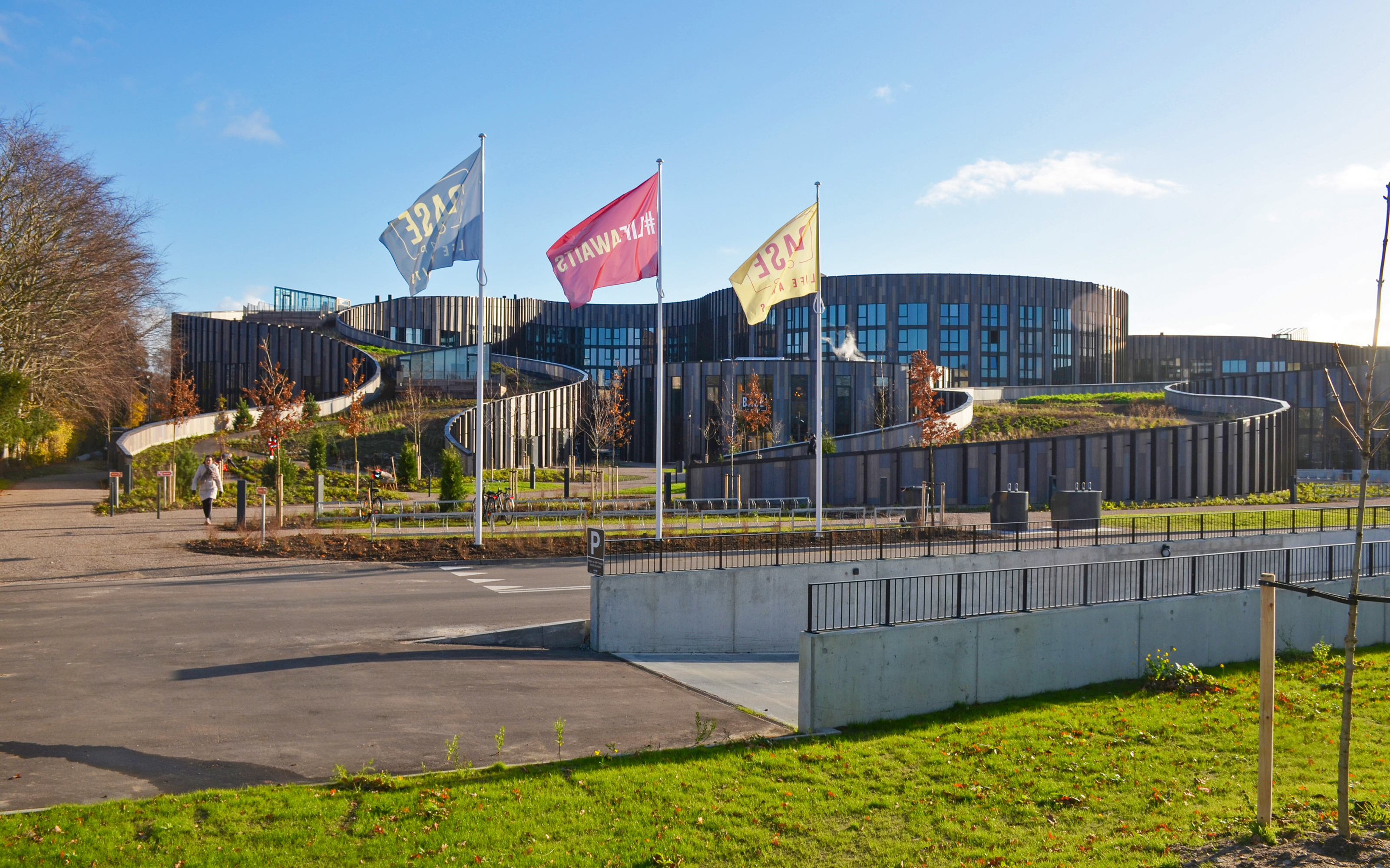 Large building with an accessible green roof from ground level